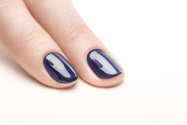 Fingernails with shiny navy blue nail polish on white background — Stock Photo