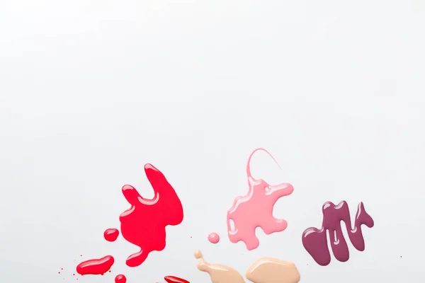 Top view of wet multicolored spills of nail polish isolated on grey — Stock Photo