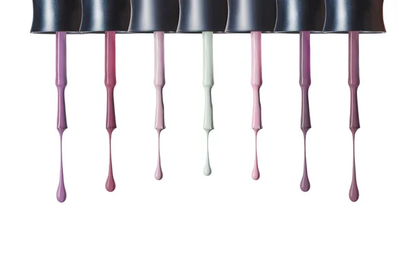 Dripping pastel nail polish on brushes isolated on white — Stock Photo