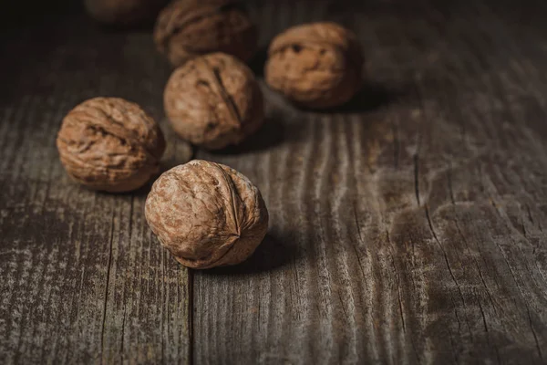 Close up view of walnuts on wooden backdrop — Stock Photo