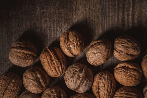 Top view of walnuts arranged on wooden surface — Stock Photo