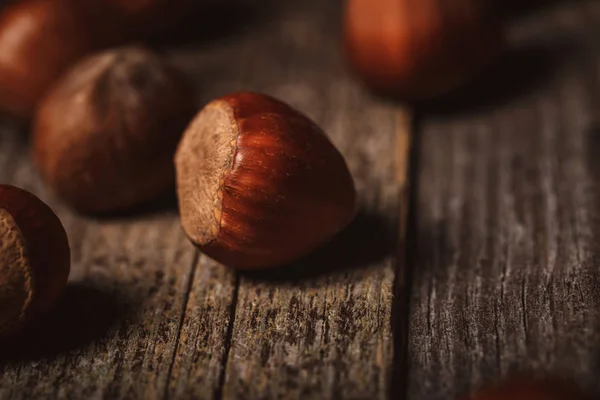 Close up view of shelled hazelnuts on wooden tabletop — Stock Photo