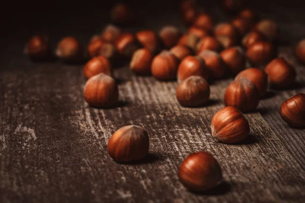 Close up view of shelled hazelnuts on wooden tabletop — Stock Photo