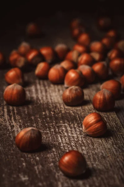 Close up view of shelled hazelnuts on wooden tabletop — Stock Photo