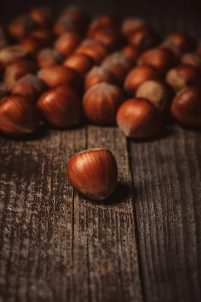 Close up view of shelled hazelnuts on wooden backdrop — Stock Photo