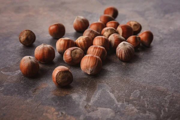 Close up view of shelled hazelnuts on grey tabletop — Stock Photo