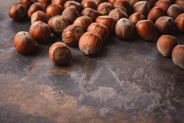 Close up view of shelled hazelnuts on grey tabletop — Stock Photo