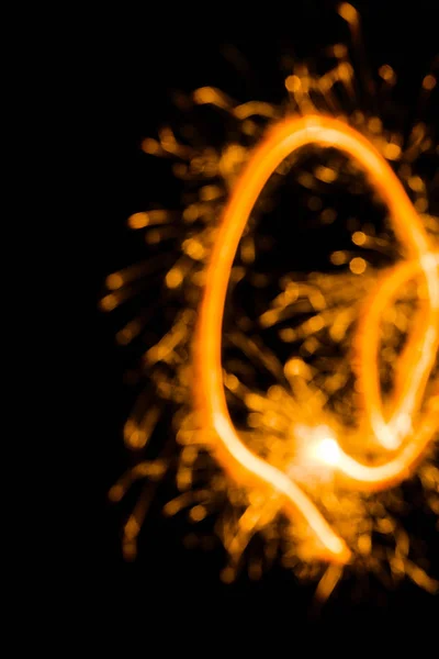 Close-up view of abstract new year sparkler on black background — Stock Photo