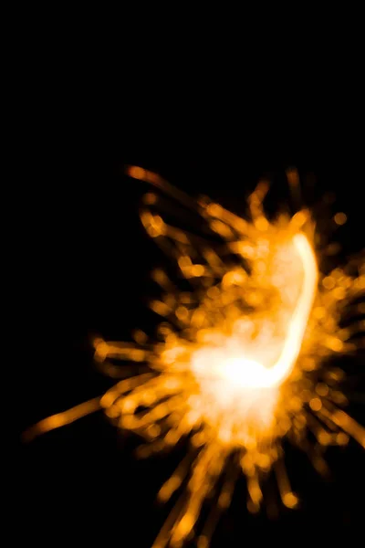 Close-up view of abstract burning new year sparkler on black background — Stock Photo