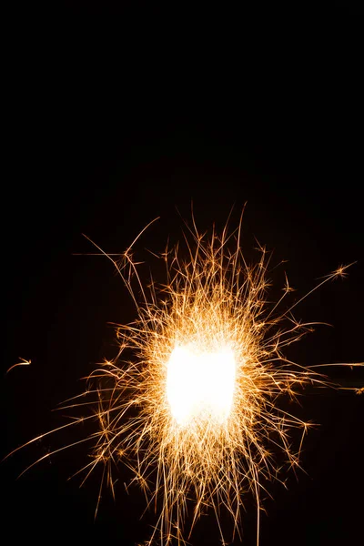 Close-up view of bright burning christmas sparkler on black background — Stock Photo