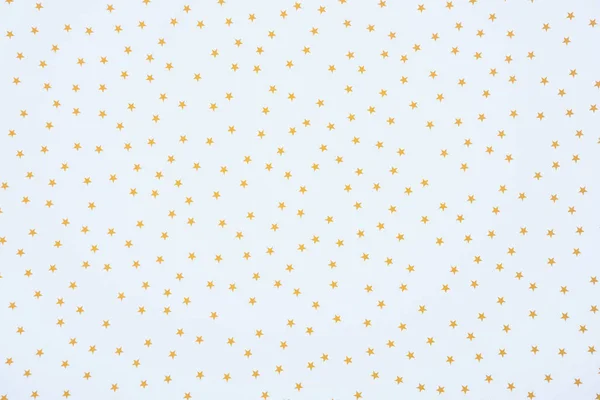 Full frame image of festive paper decorated by golden stars background — Stock Photo