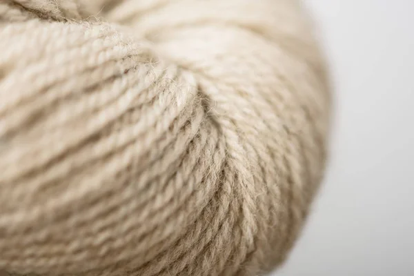 Full frame of beige knitting clew on grey background — Stock Photo