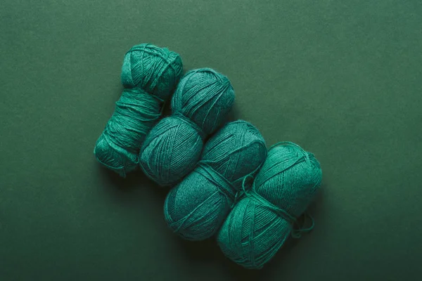 Top view of green knitting clews on green background — Stock Photo