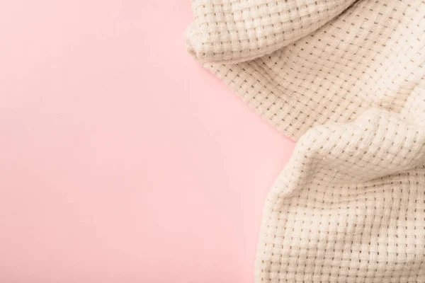 Vue de dessus de couverture tricotée blanche sur fond rose — Photo de stock