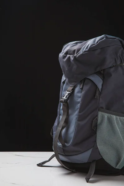 Close-up view of backpack for hiking on black background, travel concept — Stock Photo