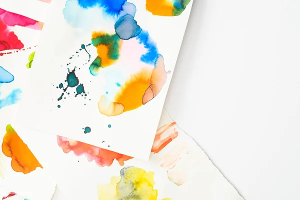 Top view of papers with abstract watercolor spills on papers with copy space — Stock Photo