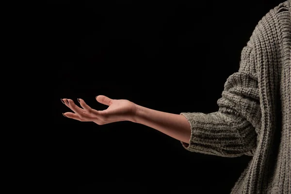 Cropped view of woman in knitted sweater isolated on black — Stock Photo