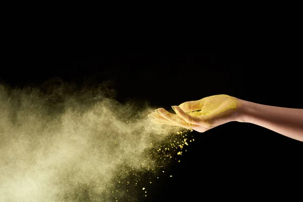 Cropped view of adult woman with yellow holi powder on black background — Stock Photo