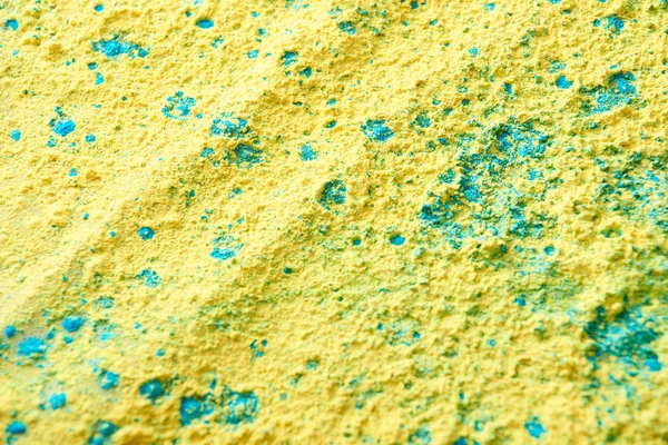 Close up of yellow and blue holi powder — Stock Photo