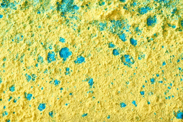 Close-up de mistura de pó holi amarelo e azul — Fotografia de Stock