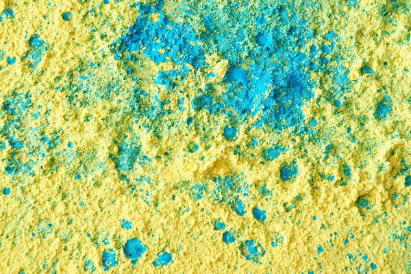 Primer plano de polvo de holi amarillo, verde y azul - foto de stock