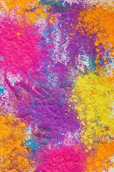 Draufsicht auf Explosion von buntem Holi-Pulver auf weißem Hintergrund — Stockfoto