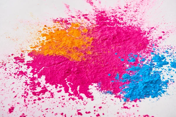 Top view of explosion of multicolored holi powder on white background — Stock Photo