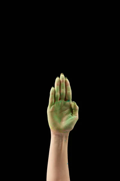 Abgeschnittene Ansicht einer Frau, die Palme mit grünem Holi-Puder zeigt, isoliert auf schwarz — Stockfoto