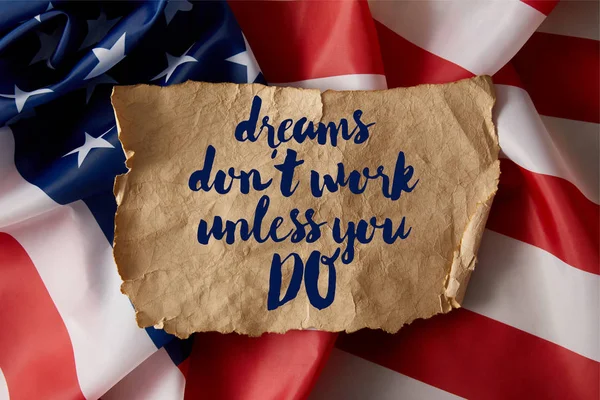 Vintage crumpled paper with dreams dont work unless you do quote on american flag — Stock Photo