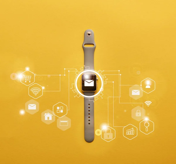 Top view of smartwatch with system notification on yellow surface — Stock Photo