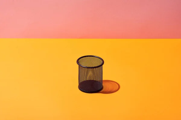 Empty pencil holder on yellow surface and pink background — Stock Photo