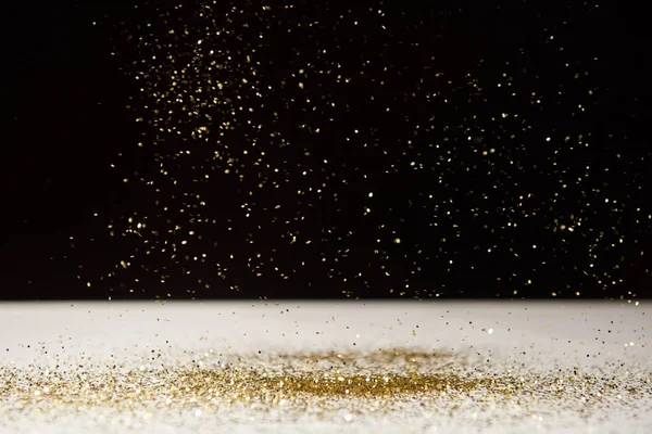 White table with bright sparkles isolated on black — Stock Photo