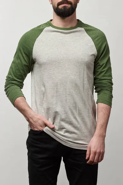 Partial view of bearded man in raglan sleeve baseball shirt with copy space isolated on grey — Stock Photo