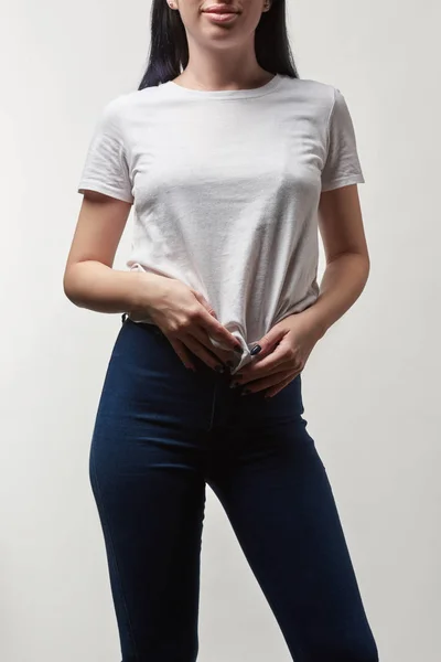 Cropped view of young woman in white t-shirt with copy space isolated on grey — Stock Photo