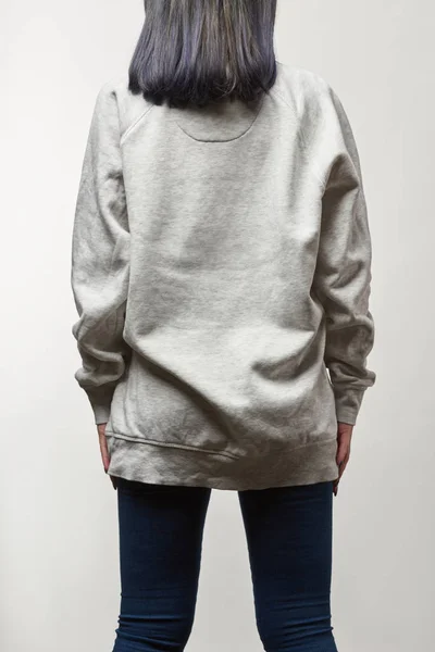 Back view of young woman in grey hoodie with copy space isolated on white — Stock Photo