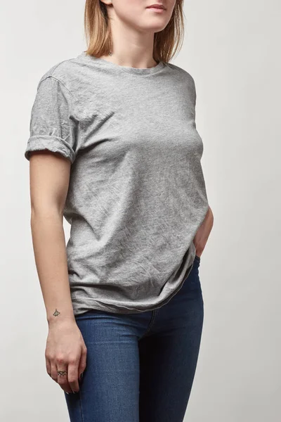 Cropped view of young woman in denim and grey t-shirt with copy space isolated on white — Stock Photo