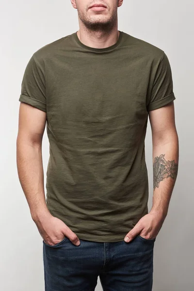 Partial view of tattooed man in khaki t-shirt with copy space isolated on grey — Stock Photo