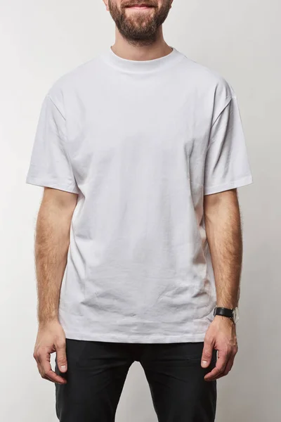 Partial view of man in white t-shirt with copy space isolated on grey — Stock Photo