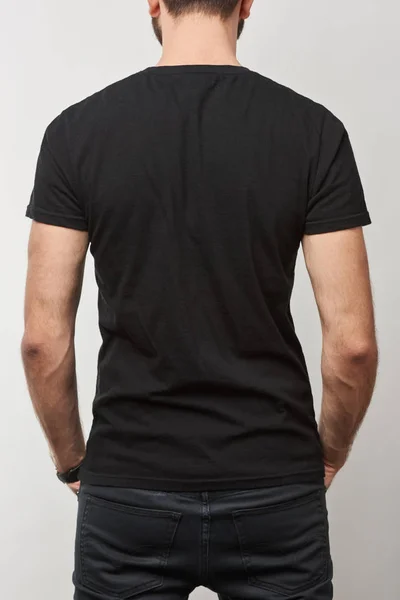 Vue arrière du t-shirt homme en coton noir avec espace de copie isolé sur gris — Photo de stock