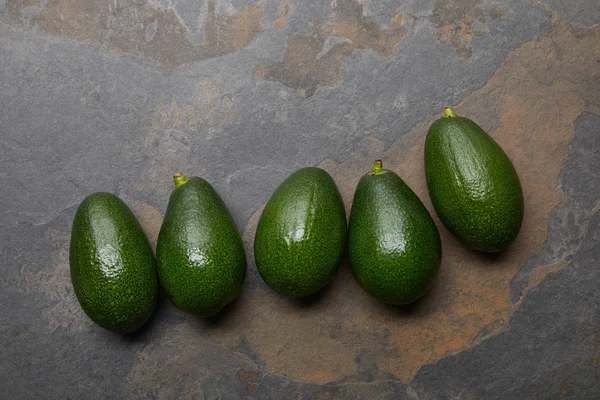 Top view of avocados on grey background — Stock Photo