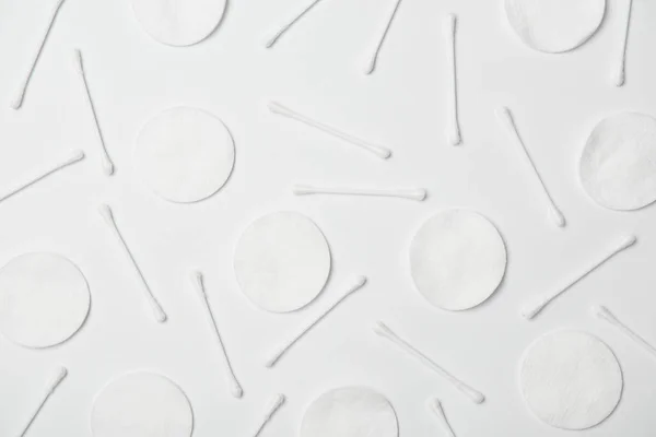 Top view of cotton cticks and cosmetic pads on white background — Stock Photo