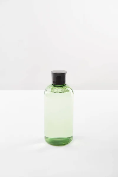 Bouteille cosmétique avec lotion sur fond blanc avec espace de copie — Photo de stock