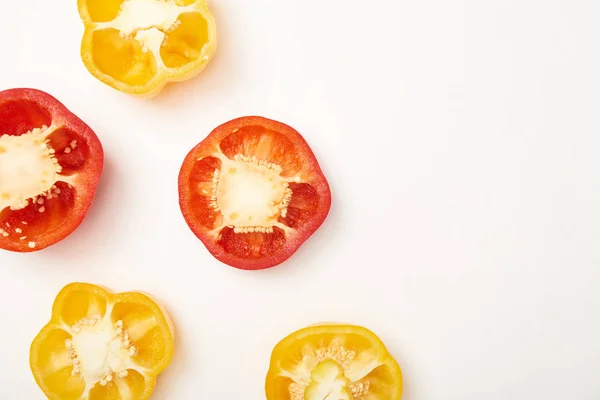Flat lay with cut bell peppers on white background — Stock Photo