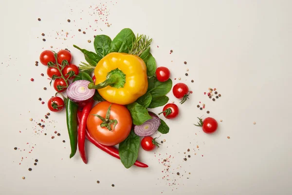 Vista superior de verduras frescas y especias sobre fondo gris - foto de stock