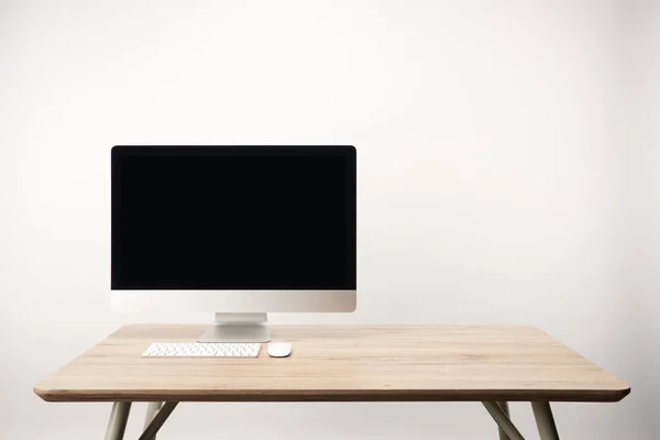 Local de trabalho com computador desktop em mesa de madeira isolada em branco com espaço de cópia — Fotografia de Stock