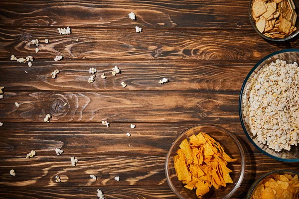 Top view of delicious snacks in bows on wooden table — Stock Photo