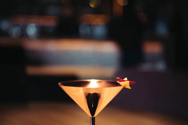 Alcoholic cocktail in metal glass decorated with chili pepper and nacho chip on dark background with copy space — Stock Photo