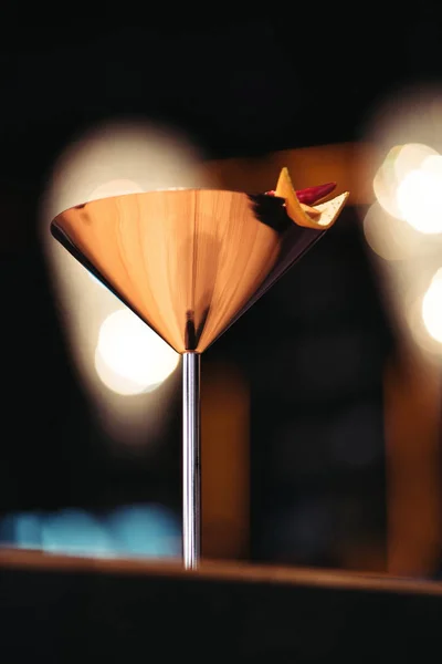 Selective focus of alcoholic cocktail in metal glass decorated with chili pepper and nacho chip on dark background — Stock Photo