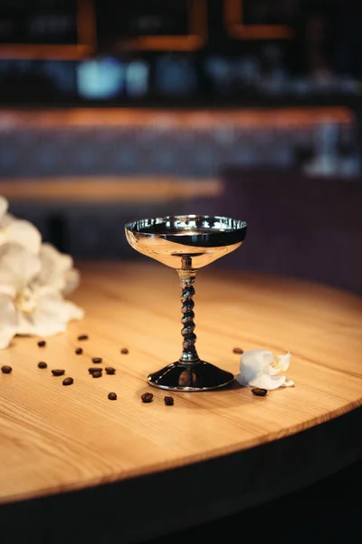 Selective focus of alcoholic cocktail in metal glass on wooden table with dark background — Stock Photo