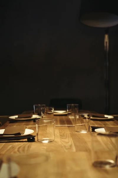 Foco seletivo da configuração da mesa na superfície de madeira com fundo preto e espaço de cópia — Fotografia de Stock